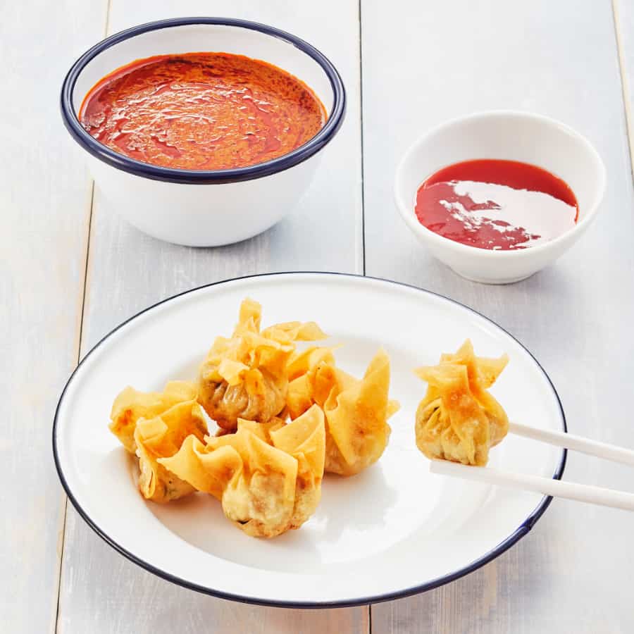 fried wantans with curry sauce and chilli sauce